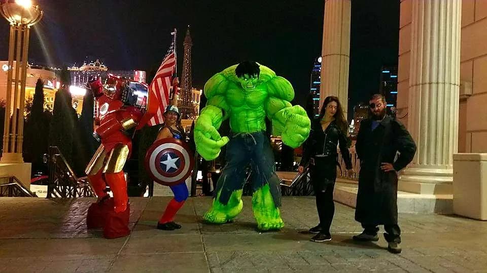 Iron Man, Captain America, Hulk, and two more costumes on the Las Vegas Strip at night