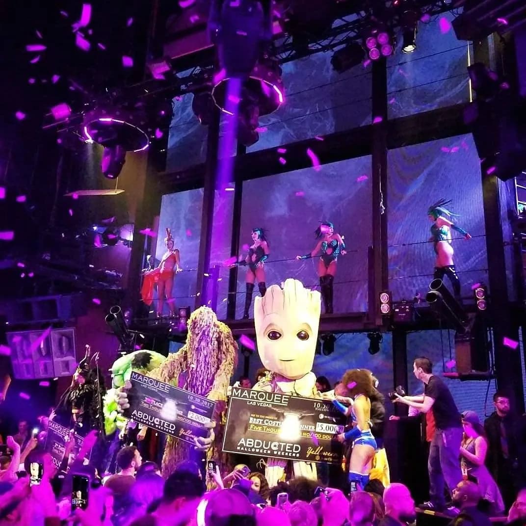 A giant Groot costume and contestants on stage at Marquee Las Vegas as confetti falls