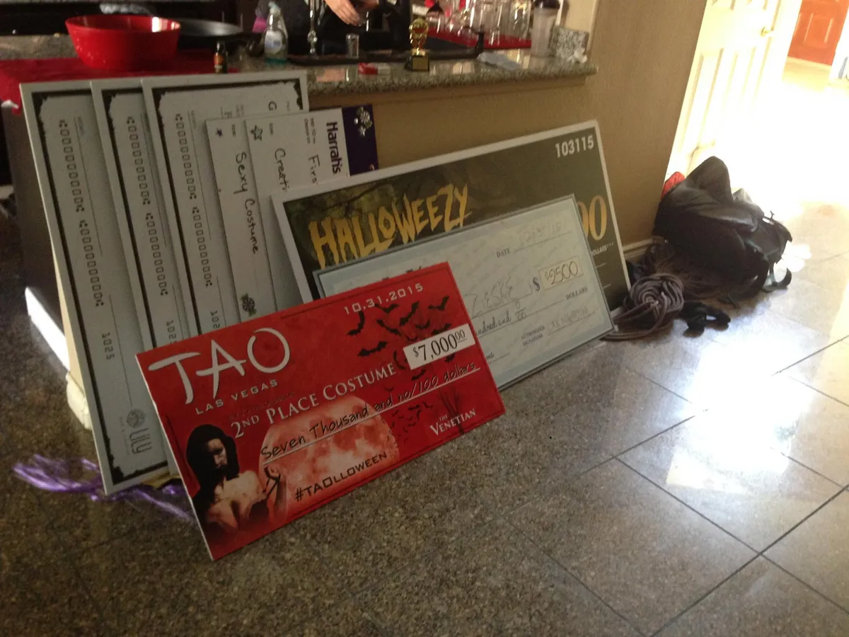 Oversized costume-contest prize checks from TAO, Harrah's, and other venues